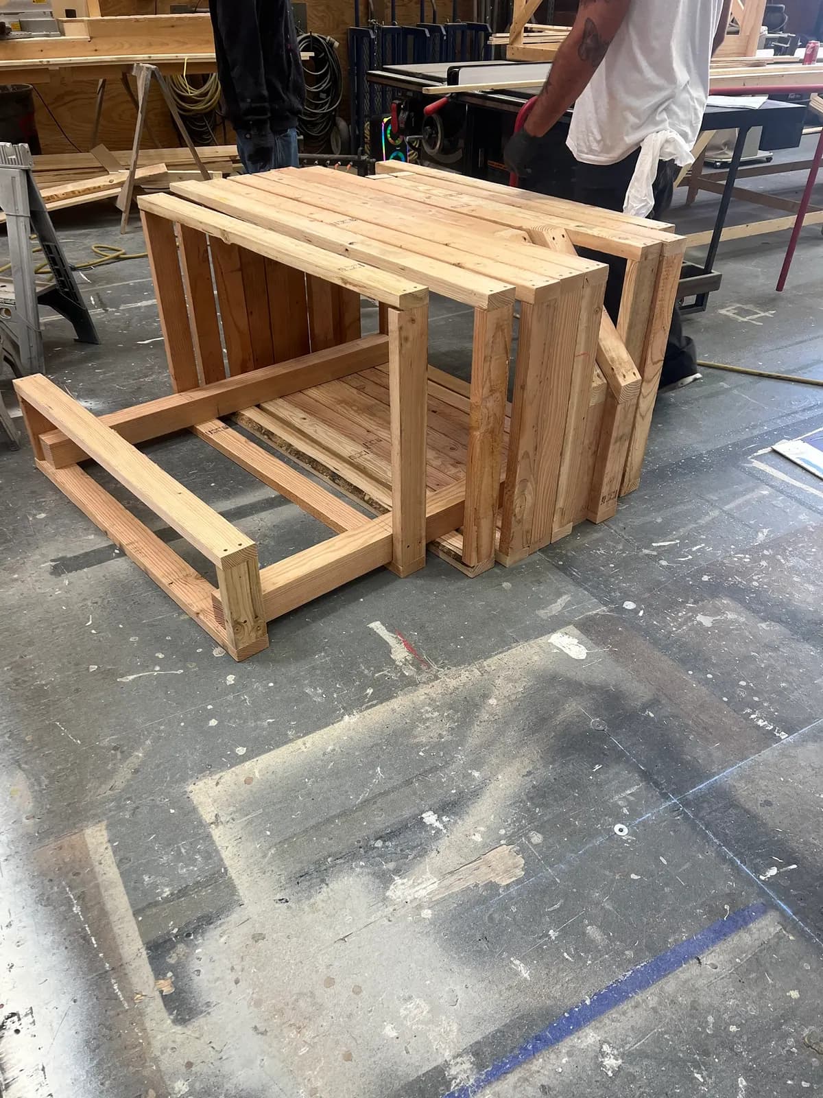 Unstained bench frames assembled on the shop floor