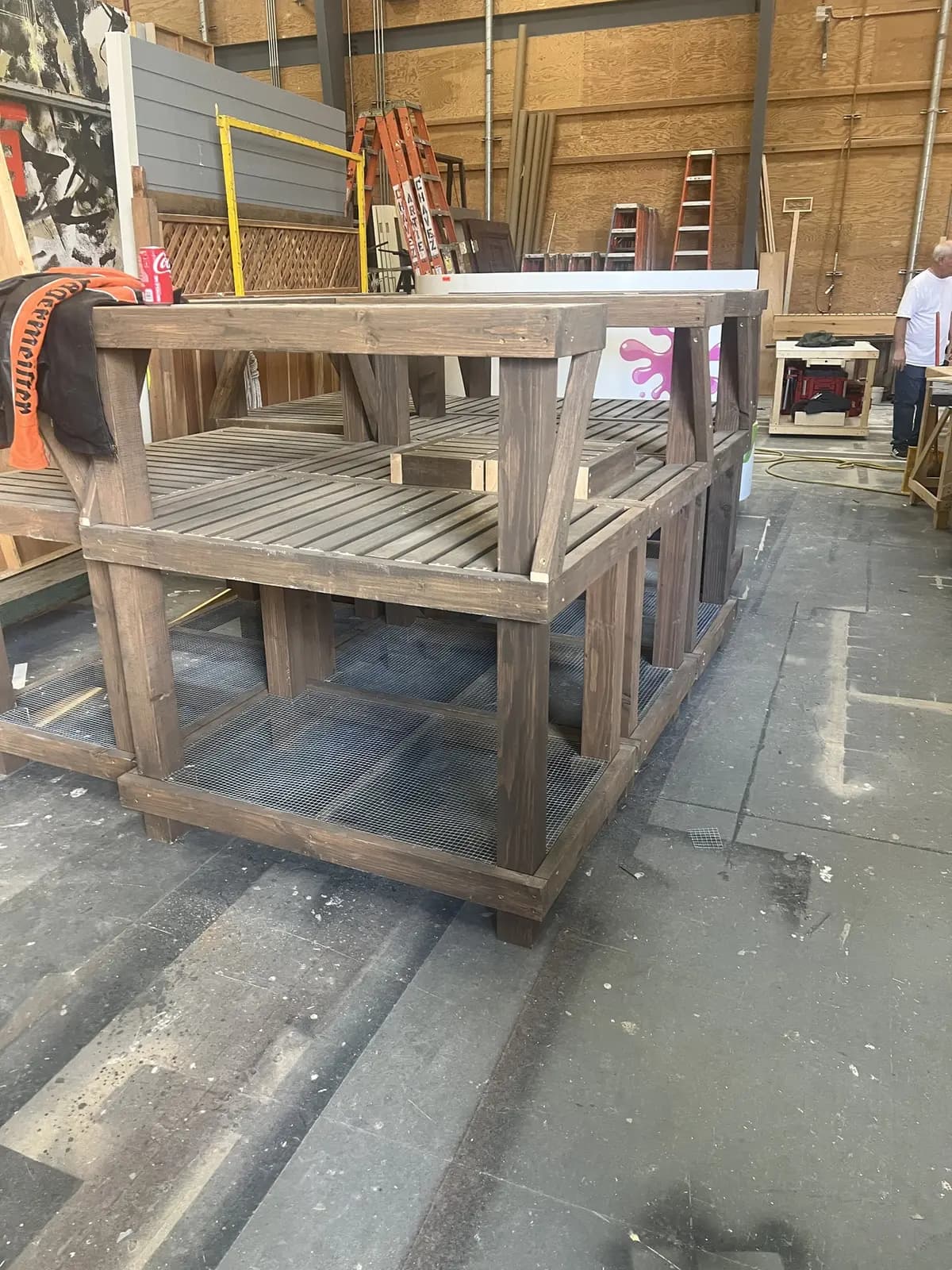 Several finished bench modules lined up together on the shop floor, ready to move